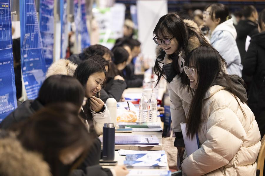 Personas en busca de empleo conversan con empleadores durante una feria laboral organizada para los graduados de 2025 de la Universidad de Heilongjiang en Harbin, en la provincia nororiental china de Heilongjiang, el 23 de diciembre de 2024. (Xinhua/Zhang Tao)
